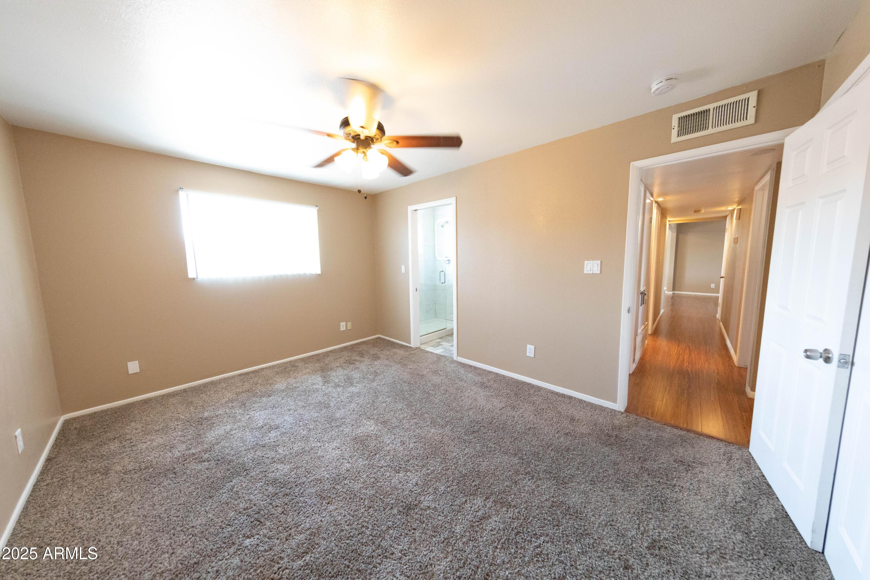 1149 West 10th Street Tempe, AZ 85281 - Photo 15 of 19 an empty room with windows and fan