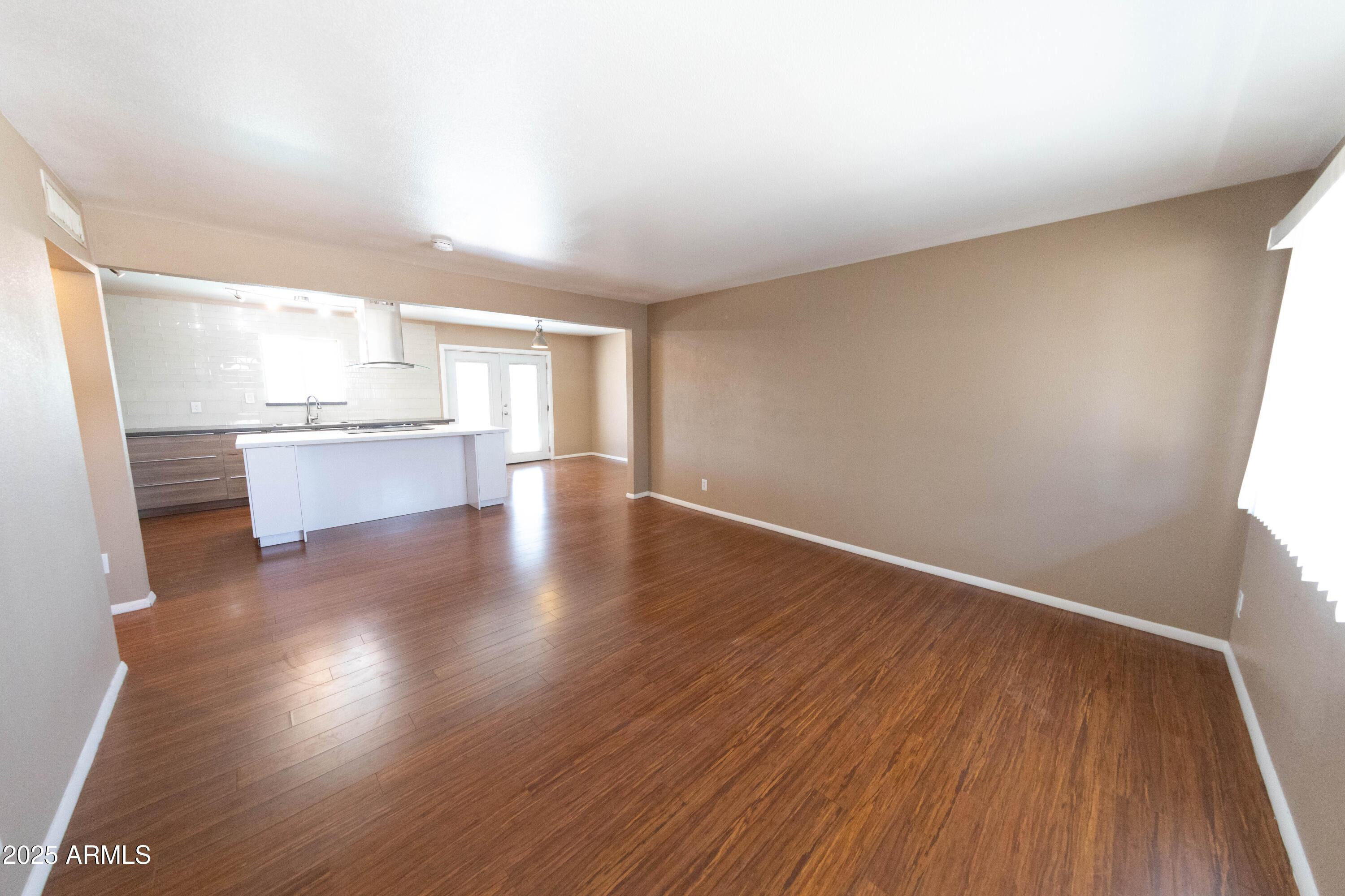 1149 West 10th Street Tempe, AZ 85281 - Photo 3 of 19 a view of a kitchen with wooden floor and a window