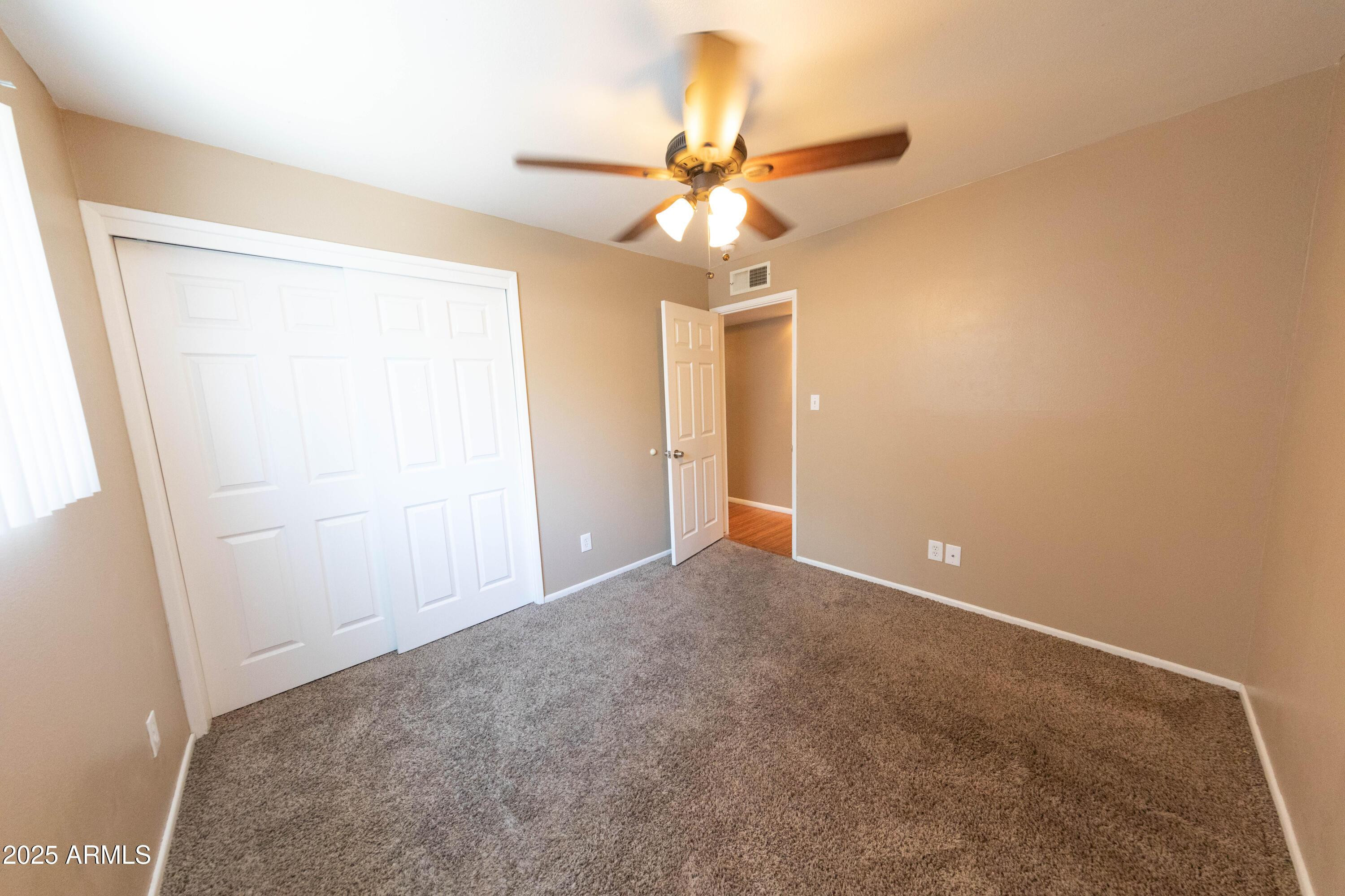 1149 West 10th Street Tempe, AZ 85281 - Photo 9 of 19 an empty room with a ceiling fan and a window