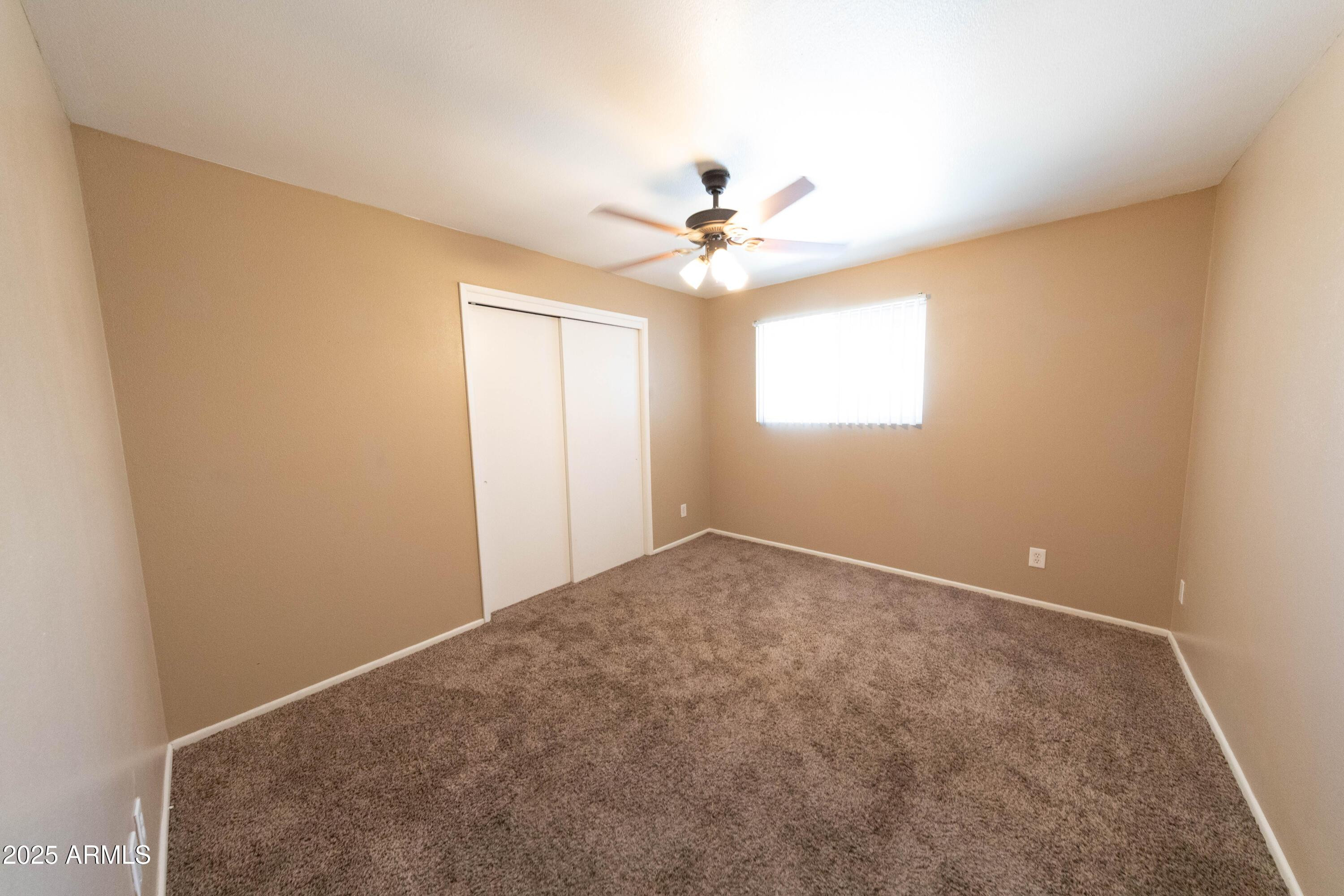 1149 West 10th Street Tempe, AZ 85281 - Photo 10 of 19 an empty room with windows and fan