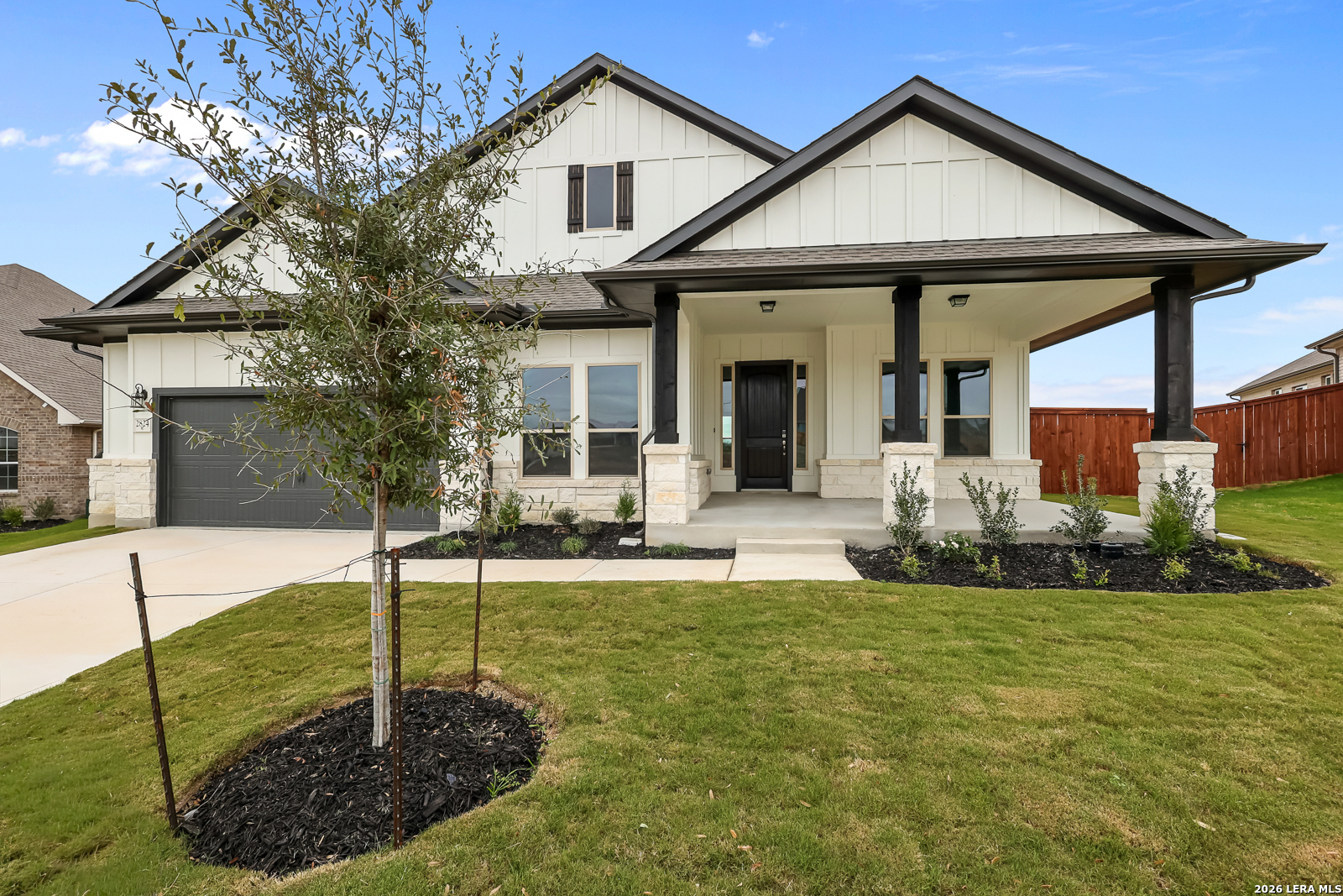 a view of a house with backyard and sitting area