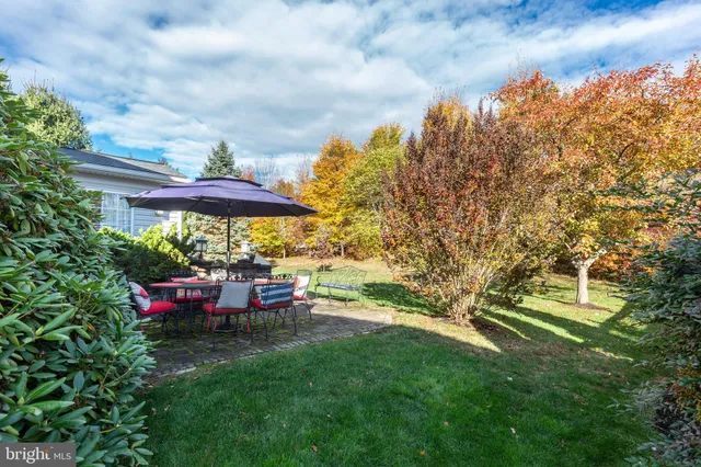 a view of a house with backyard and sitting area