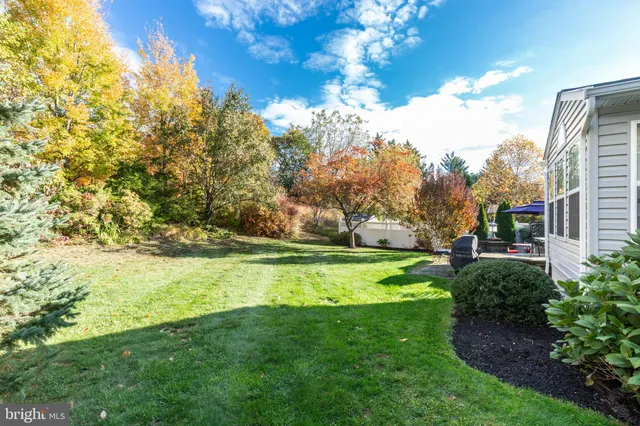 a backyard of a house with a yard and seating space