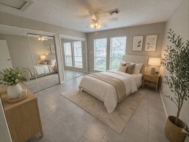 2277 South Kirkwood Road, Unit 104 Houston, TX 77077 - Photo 1 of 12 a spacious bedroom with a large bed and windows
