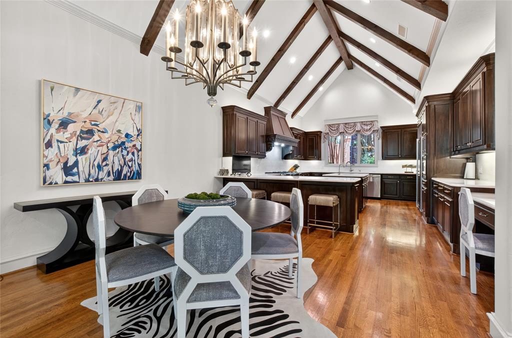 11836 Preston Brook Place Dallas, TX 75230 - Photo 14 of 40 Dining space with high vaulted ceiling, light wood-style floors, beamed ceiling, a chandelier, and recessed lighting