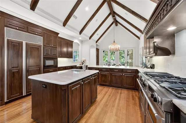 a kitchen with stainless steel appliances granite countertop a stove a sink dishwasher and a refrigerator