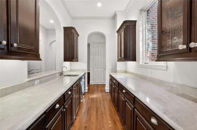 a kitchen with granite countertop a sink and a stove