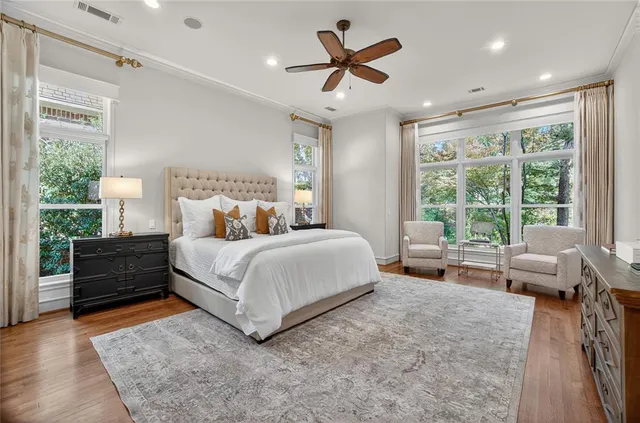 a bedroom with a large bed and a large window