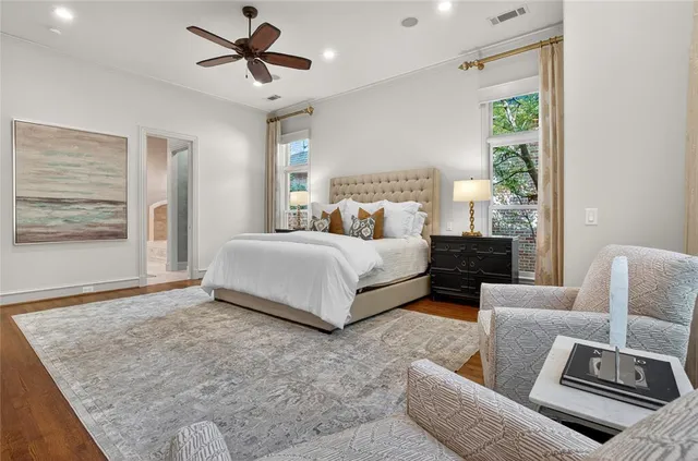 a spacious bedroom with a bed couch and window