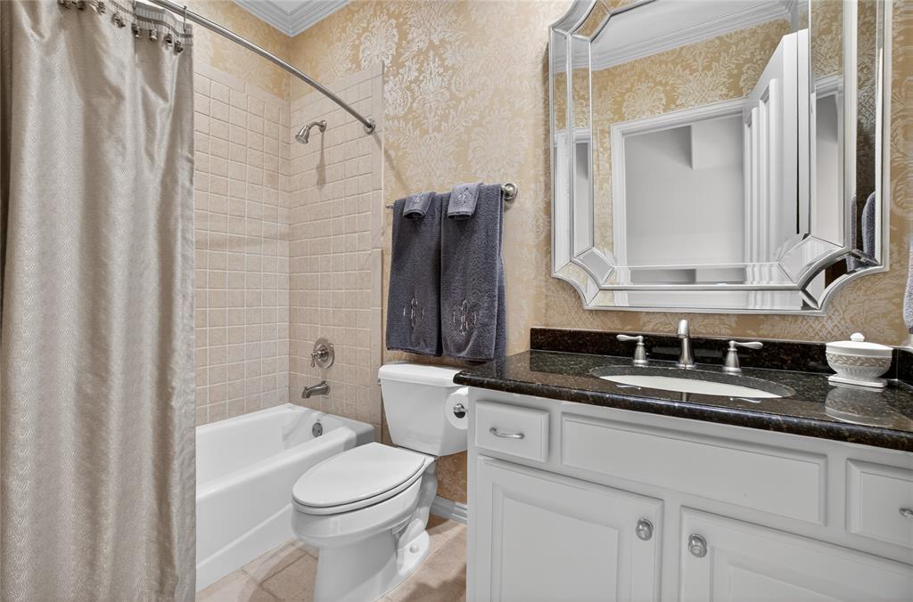 11836 Preston Brook Place Dallas, TX 75230 - Photo 24 of 40 Full bath featuring shower / bath combo with shower curtain, vanity, and crown molding