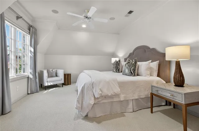 a bedroom with a bed and a lamp