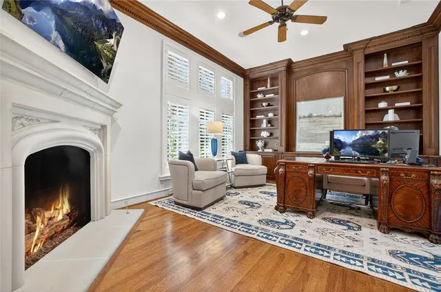 a living room with furniture a fireplace and a flat screen tv