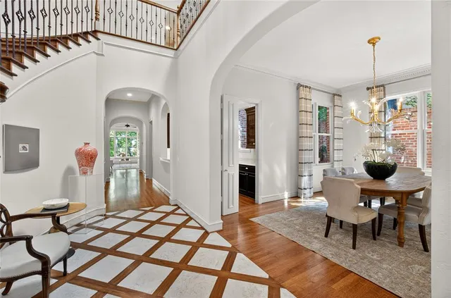 a living room with furniture a table and a chandelier