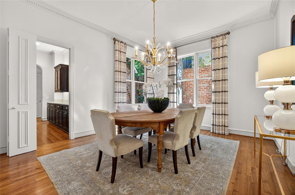 11836 Preston Brook Place Dallas, TX 75230 - Photo 7 of 40 Dining space with ornamental molding, wood finished floors, and a chandelier