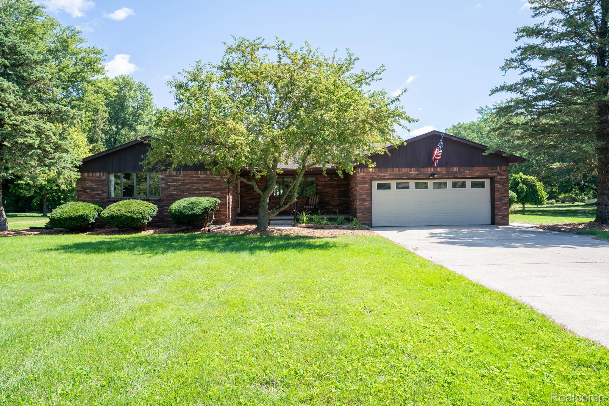 12900 Maxwell Road Carleton, MI 48117 - Photo 1 of 59 Brick exterior with a prominent front-facing garage