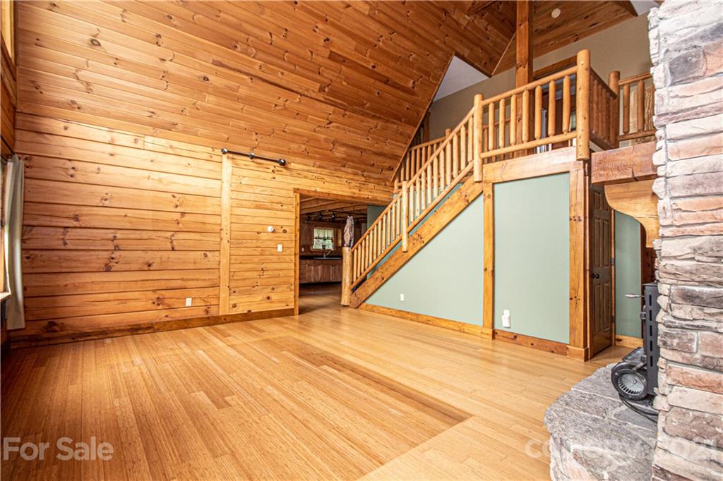 175 Buckeye Branch Drive Clyde, NC 28721 - Photo 13 of 23 a view of an empty room with wooden floor and a window