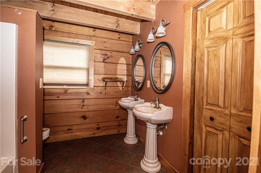 175 Buckeye Branch Drive Clyde, NC 28721 - Photo 16 of 23 a bathroom with a sink a toilet and a mirror