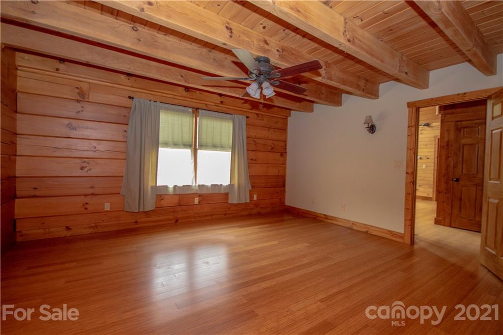 175 Buckeye Branch Drive Clyde, NC 28721 - Photo 17 of 23 a view of empty room with wooden floor and fan