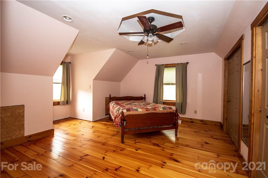175 Buckeye Branch Drive Clyde, NC 28721 - Photo 19 of 23 a living room with a bed furniture and a window