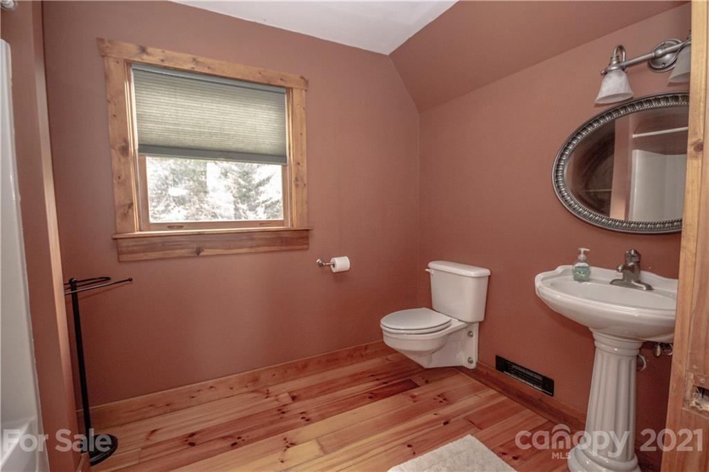 175 Buckeye Branch Drive Clyde, NC 28721 - Photo 20 of 23 a bathroom with a sink toilet and a mirror