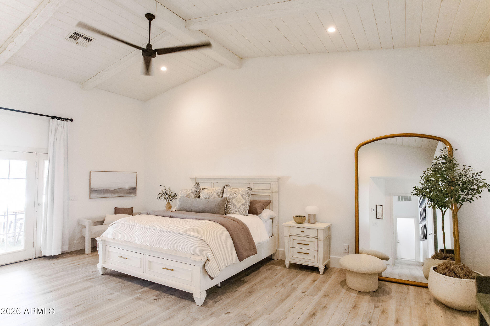 19049 East Cloud Road Queen Creek, AZ 85142 - Photo 25 of 75 a spacious bedroom with a bed and wooden floor