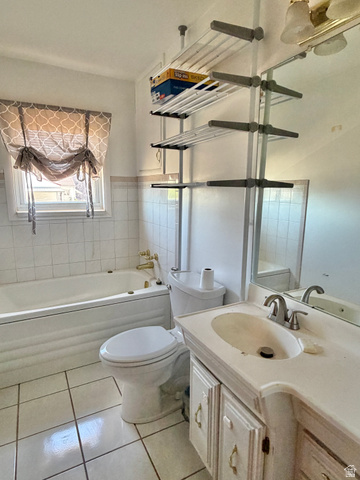 196 North 5th West Price, UT 84501 - Photo 9 of 27 Bathroom with a built-in tub, white tiled flooring, a single-sink vanity, and a mounted mirror