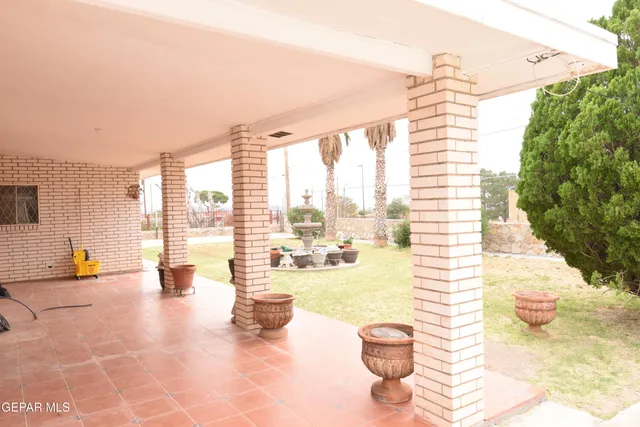 a view of a house with backyard porch and furniture