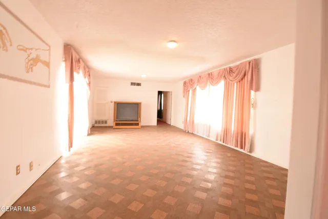 a bedroom with furniture and a large window