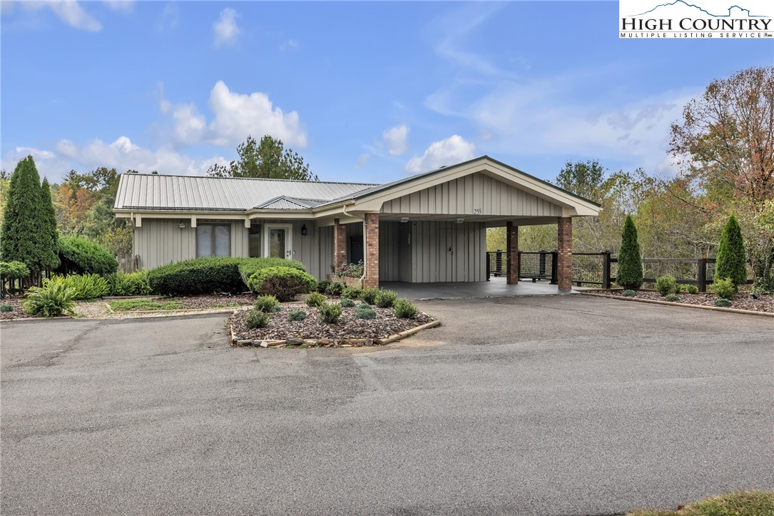 a front view of a house with a garden and patio