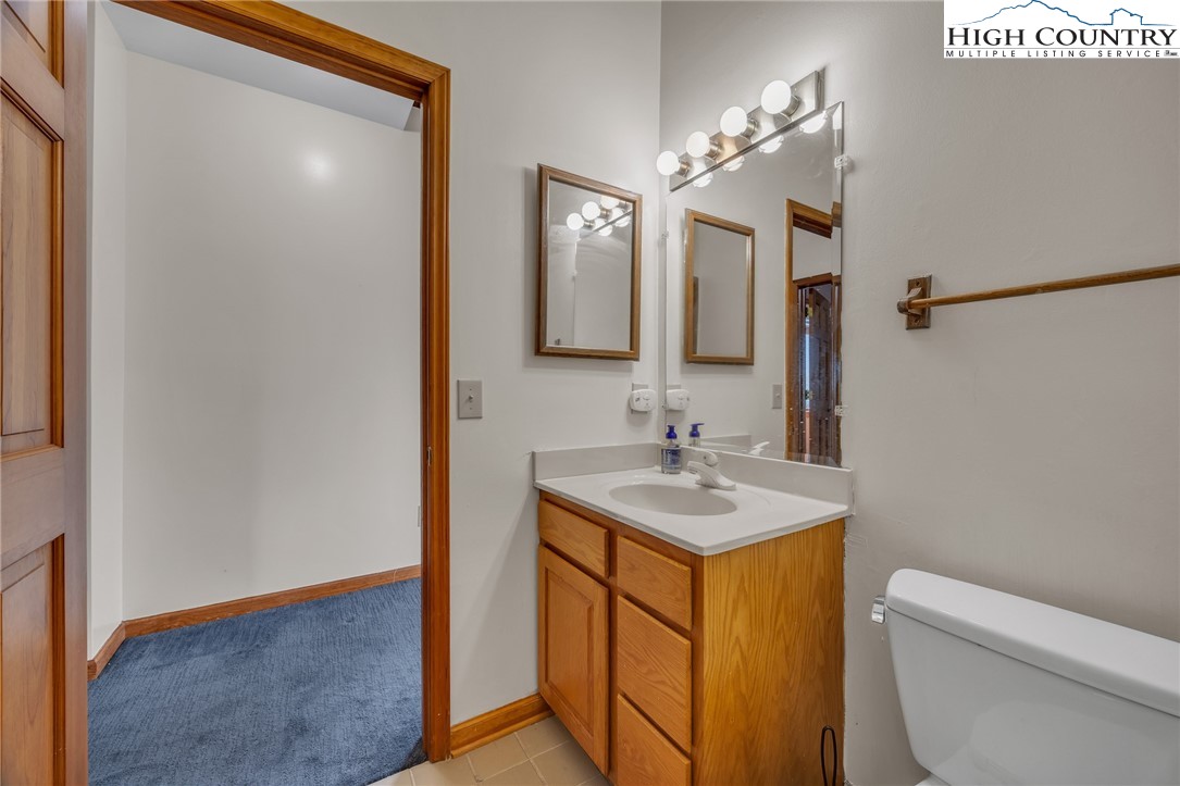 255 Clear View Ridge Crumpler, NC 28617 - Photo 25 of 33 a bathroom with a sink a toilet a mirror and vanity