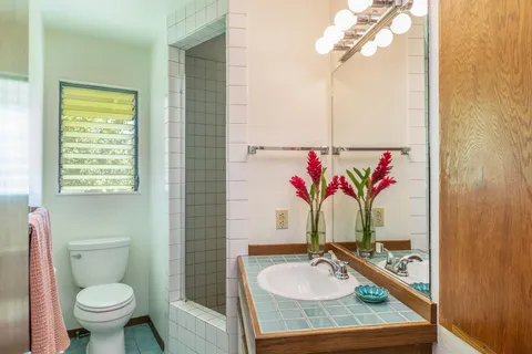 a bathroom with a granite countertop sink and a mirror
