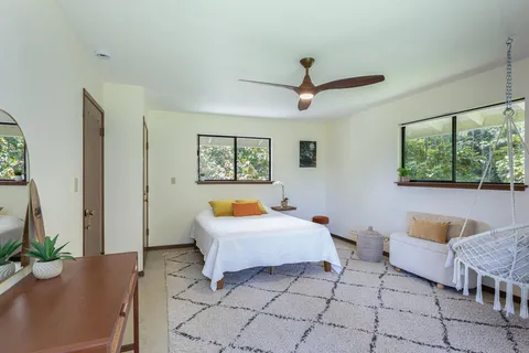 a bedroom with furniture and a window