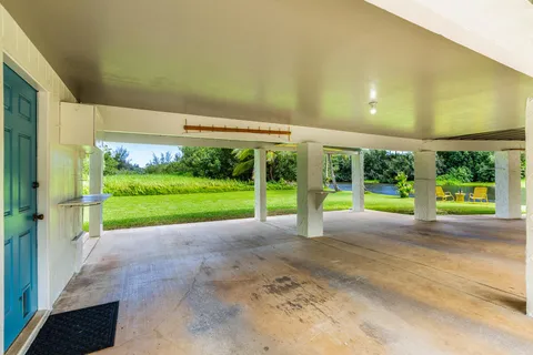 a view of an house with backyard and porch