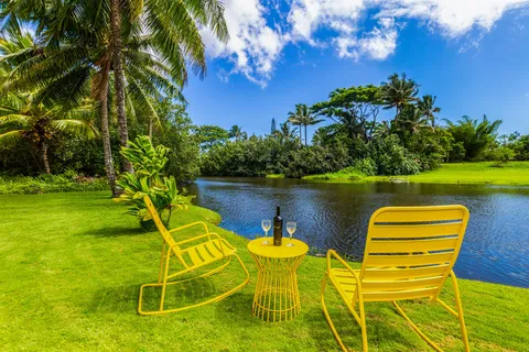 a view of a lake with couches and wooden floor