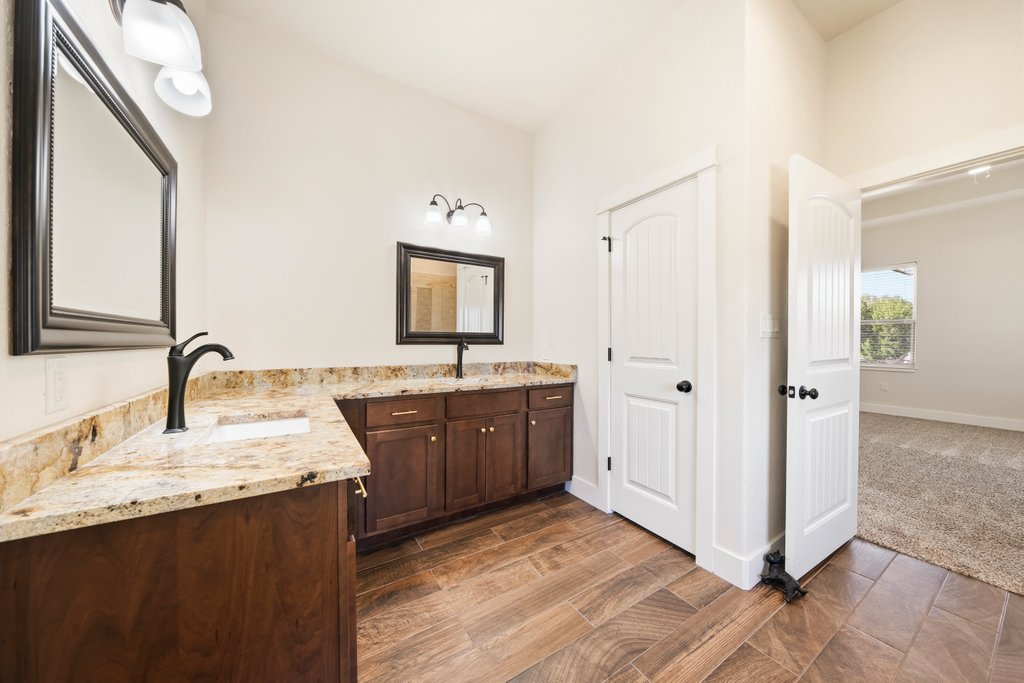 541 Stars And Stripes Fischer, TX 78623 - Photo 13 of 26 Dual sinks welcome you with an abundance of counter space. Door in photo is toilet.