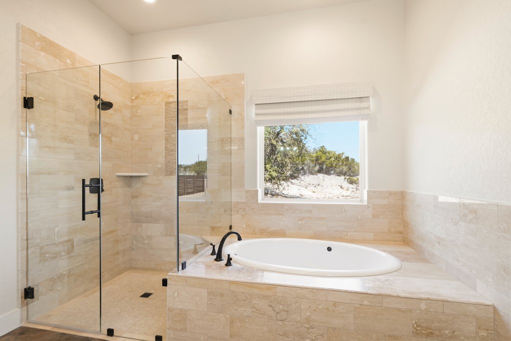 541 Stars And Stripes Fischer, TX 78623 - Photo 14 of 26 Seamless and spacious describes this shower and a jetted tub to soak your worries away.