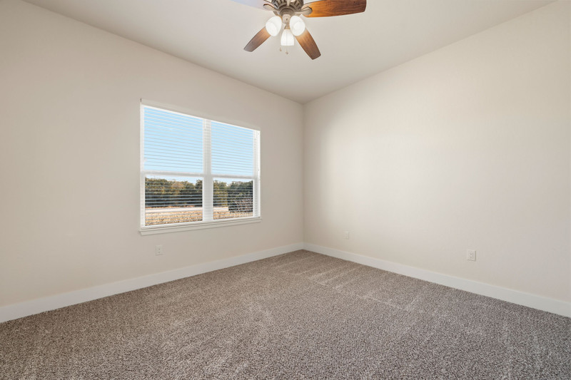 541 Stars And Stripes Fischer, TX 78623 - Photo 18 of 26 Other view of one of the two secondary bedrooms with plenty of natural light.