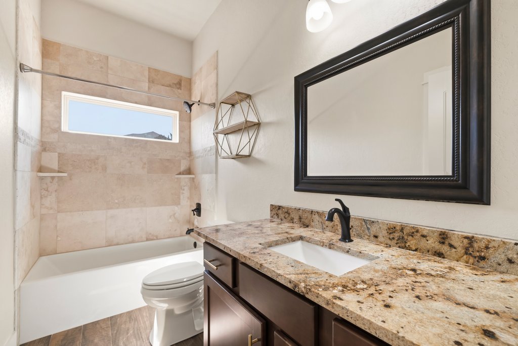 541 Stars And Stripes Fischer, TX 78623 - Photo 19 of 26 Spacious secondary full bathroom with an abundance of granite counter space and soft close drawers and cabinets.