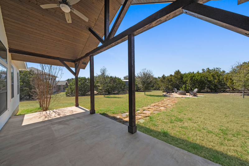 541 Stars And Stripes Fischer, TX 78623 - Photo 22 of 26 Covered and spacious describes this patio overlooking 1 acre of property.