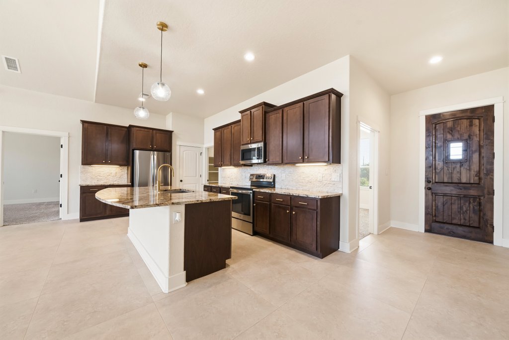 541 Stars And Stripes Fischer, TX 78623 - Photo 5 of 26 Kitchen featuring granite countertops and soft close drawers and cabinets.