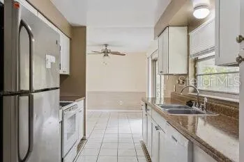 a large kitchen with stainless steel appliances granite countertop a stove and a sink