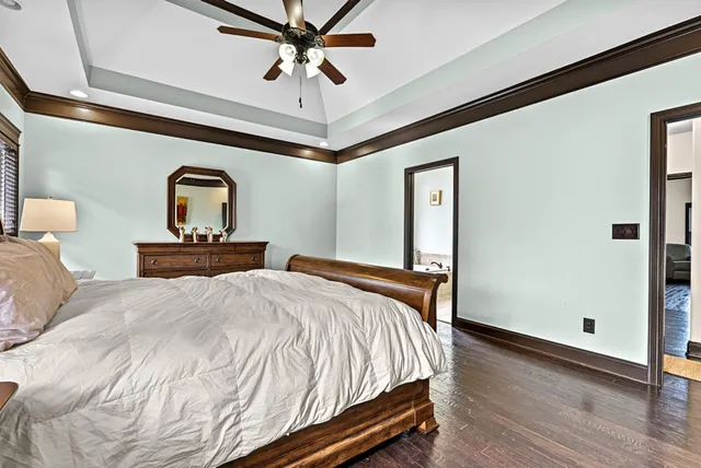 a bathroom with a granite countertop sink a toilet and a mirror