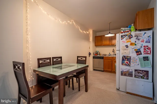 a view of a dining room with furniture and a kitchen