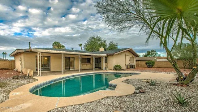 a view of house with backyard space and windows