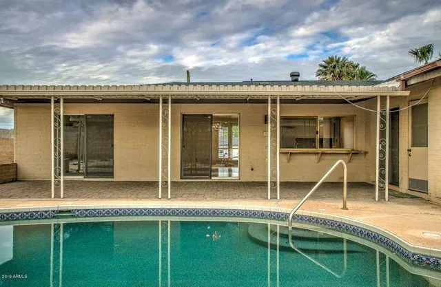 a view of swimming pool with patio