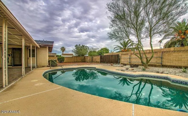 a view of kitchen with furniture and a ceiling fan
