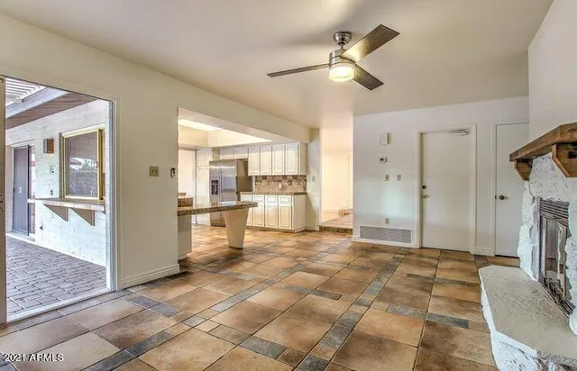 a view of kitchen with windows and refrigerator