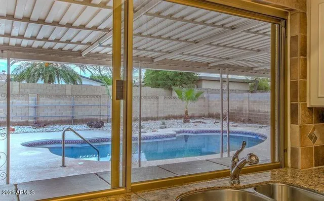 a kitchen with granite countertop a refrigerator and a sink