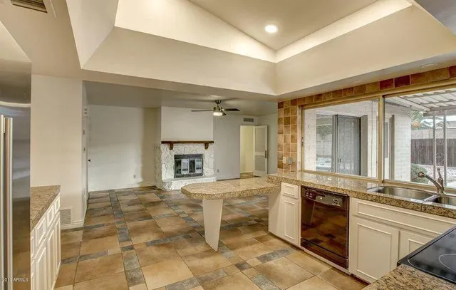 an empty room with chandelier fan