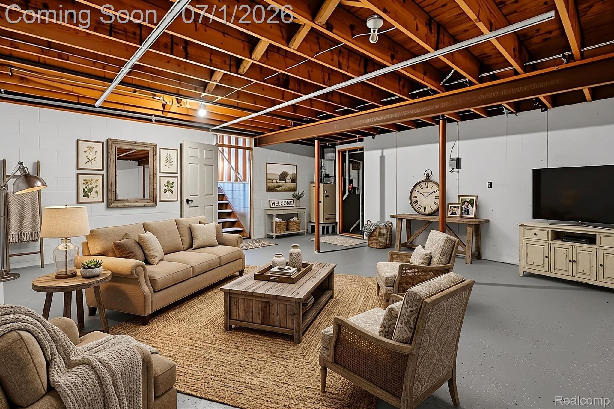 4762 Lonsberry Road Columbiaville, MI 48421 - Photo 29 of 36 Spacious lower-level living area featuring an exposed wood beam ceiling, painted concrete flooring, a paneled door, and a staircase
